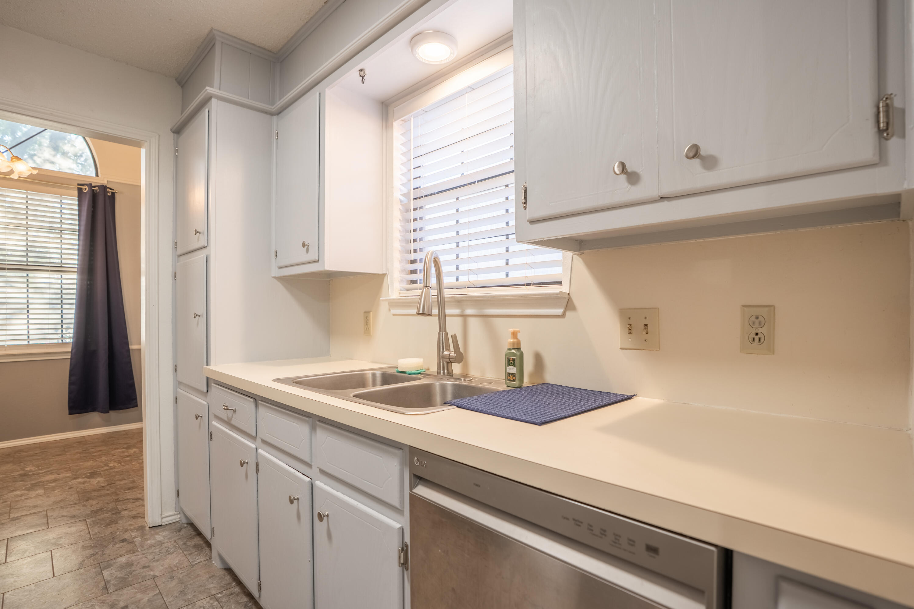 512 North Grover Avenue Lubbock, TX 79416 - Photo 8 of 34 a kitchen with granite countertop white cabinets and a sink