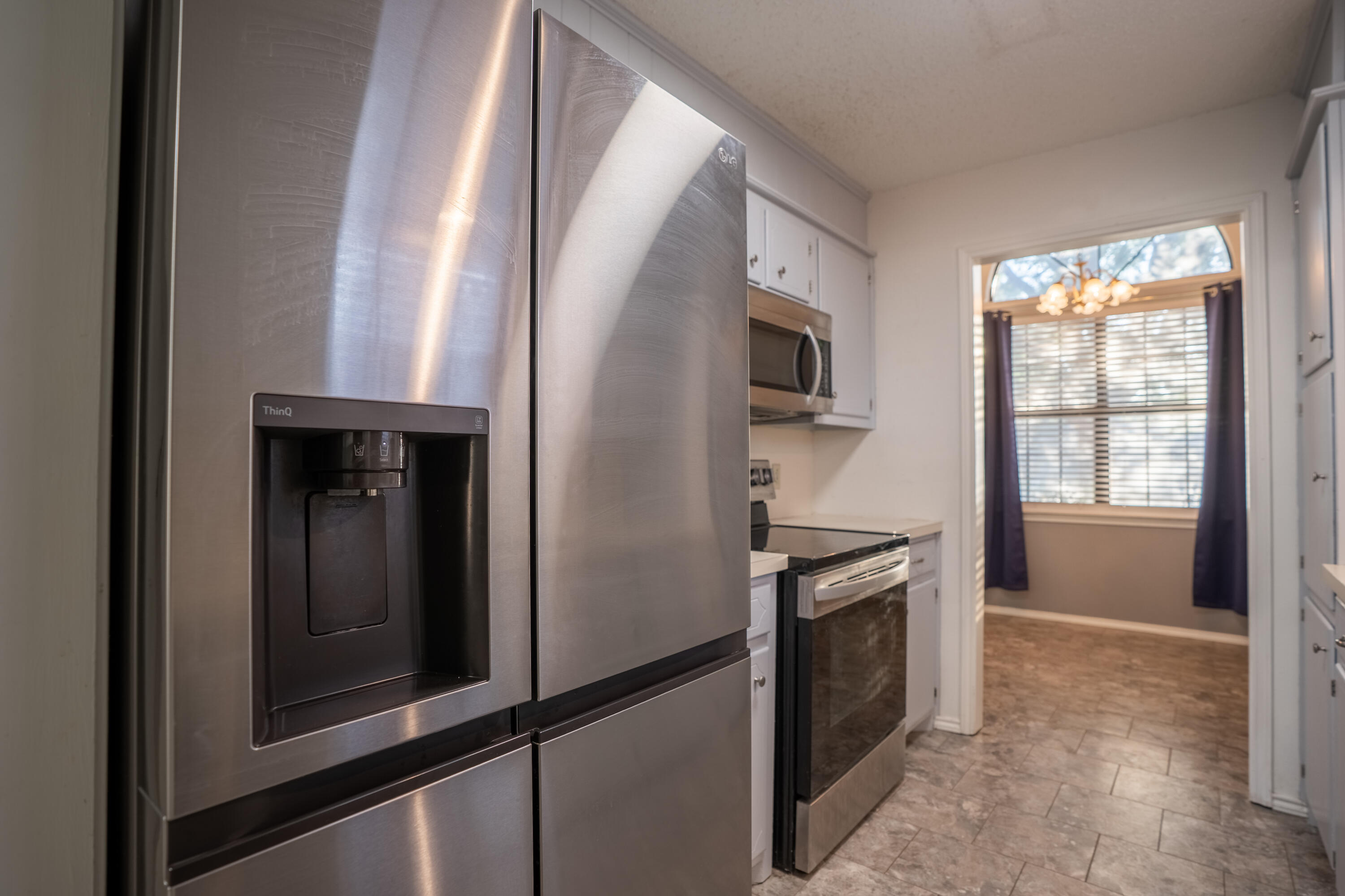 512 North Grover Avenue Lubbock, TX 79416 - Photo 10 of 34 a kitchen with a refrigerator and a window