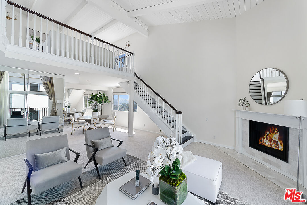 2385 Roscomare Road Los Angeles, CA 90077 - Photo 1 of 38 a living room with furniture a fireplace and a potted plant