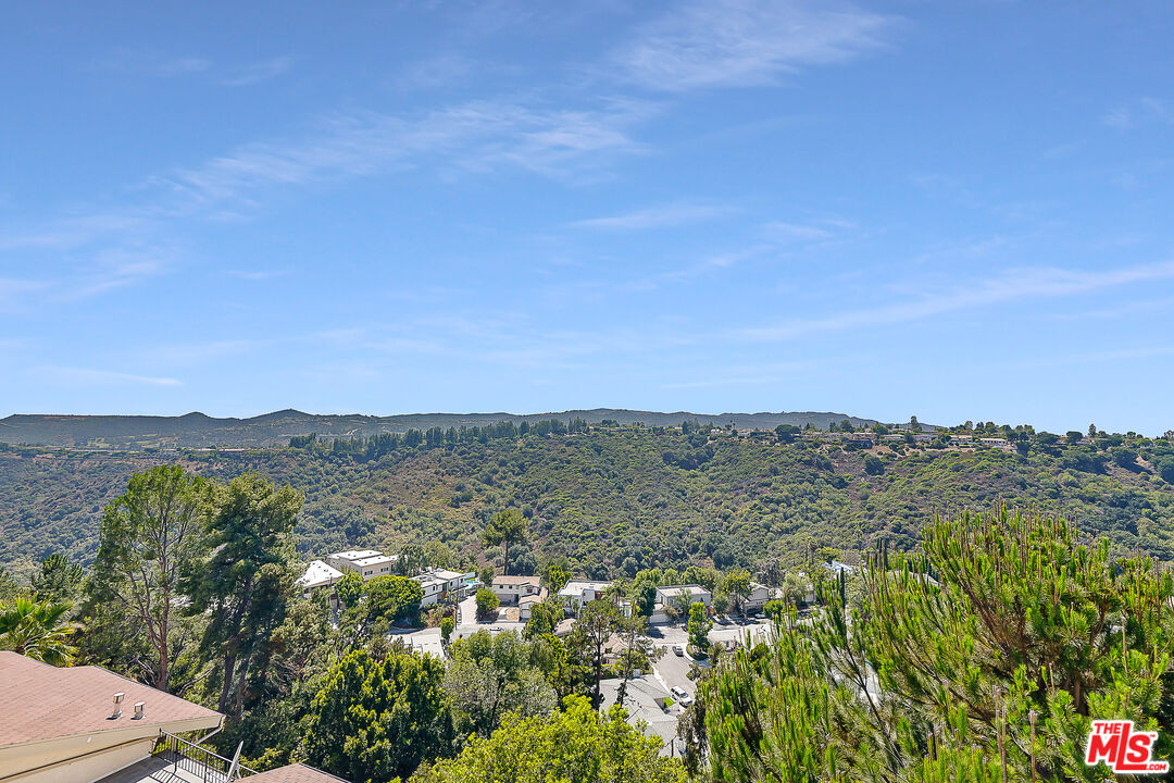 2385 Roscomare Road Los Angeles, CA 90077 - Photo 12 of 38 a view of a mountain with lake in the background