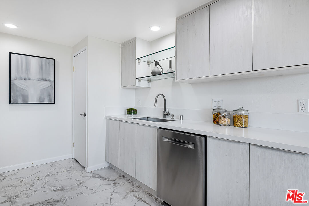 2385 Roscomare Road Los Angeles, CA 90077 - Photo 14 of 38 a kitchen with stainless steel appliances granite countertop a sink and a refrigerator
