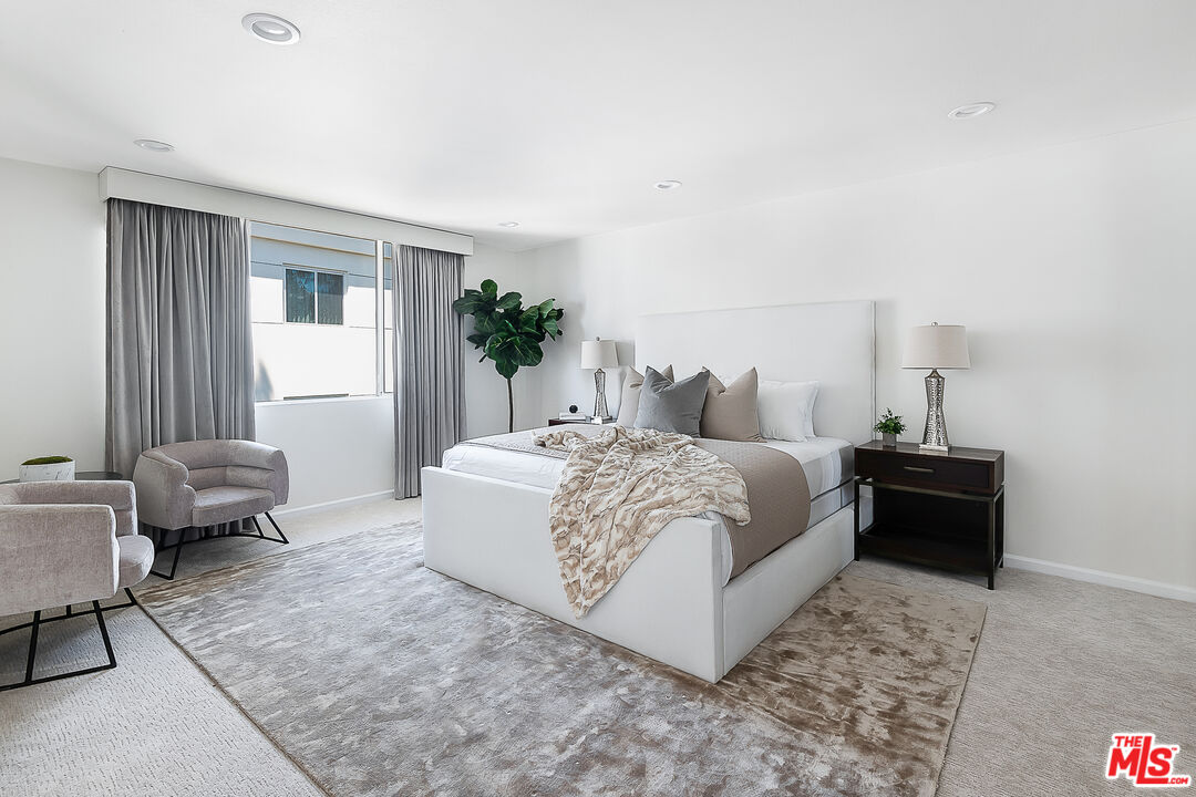 2385 Roscomare Road Los Angeles, CA 90077 - Photo 17 of 38 a bedroom with a bed and a couch