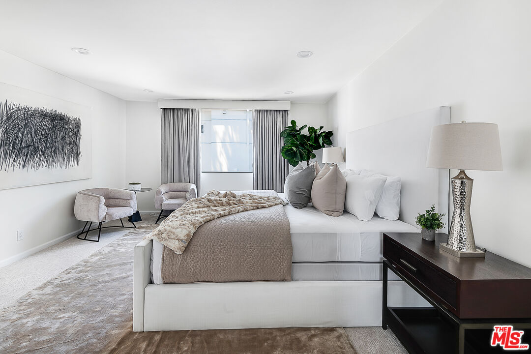 2385 Roscomare Road Los Angeles, CA 90077 - Photo 18 of 38 a bedroom with a bed and a potted plant