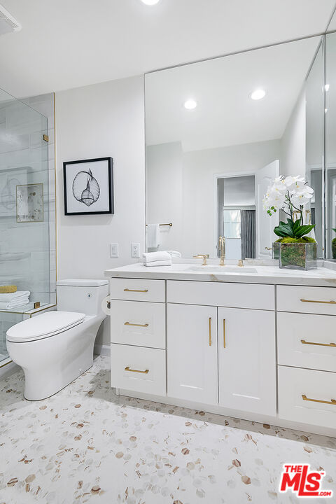 2385 Roscomare Road Los Angeles, CA 90077 - Photo 19 of 38 a bathroom with a sink a toilet and a mirror