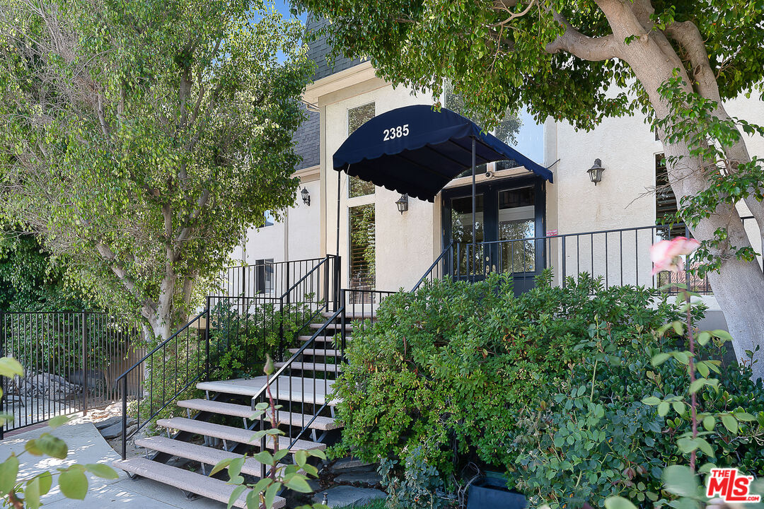 2385 Roscomare Road Los Angeles, CA 90077 - Photo 2 of 38 a front view of a house with a yard