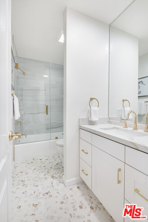 2385 Roscomare Road Los Angeles, CA 90077 - Photo 24 of 38 a bathroom with a sink and a mirror