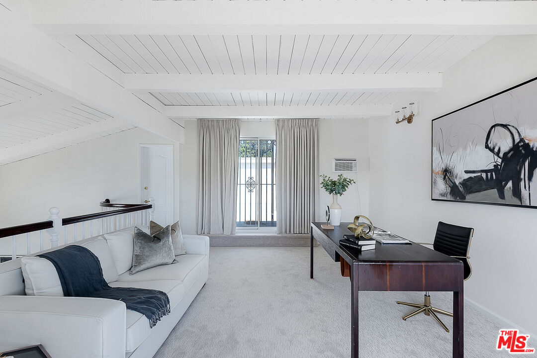 2385 Roscomare Road Los Angeles, CA 90077 - Photo 25 of 38 a living room with furniture and wooden floor