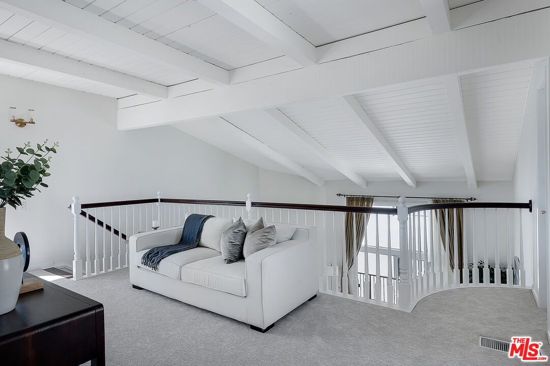 2385 Roscomare Road Los Angeles, CA 90077 - Photo 27 of 38 a white bed sitting in a room next to a window