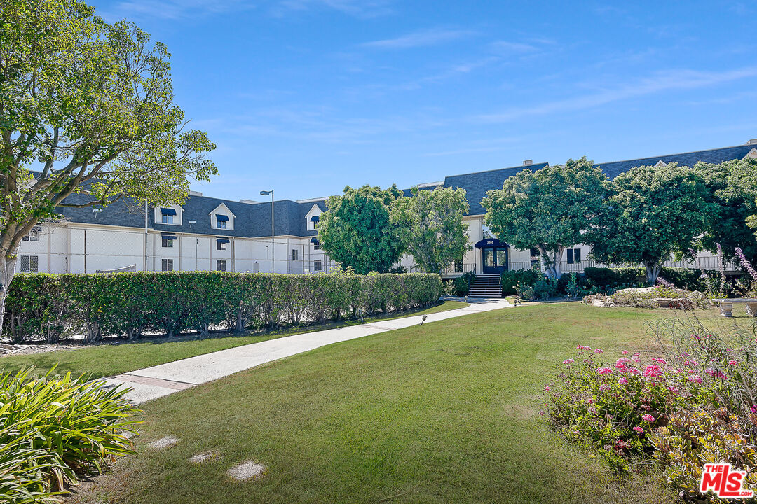 2385 Roscomare Road Los Angeles, CA 90077 - Photo 3 of 38 a view of a house with a big yard and potted plants