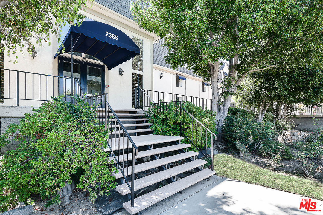 2385 Roscomare Road Los Angeles, CA 90077 - Photo 34 of 38 a view of a house with a yard