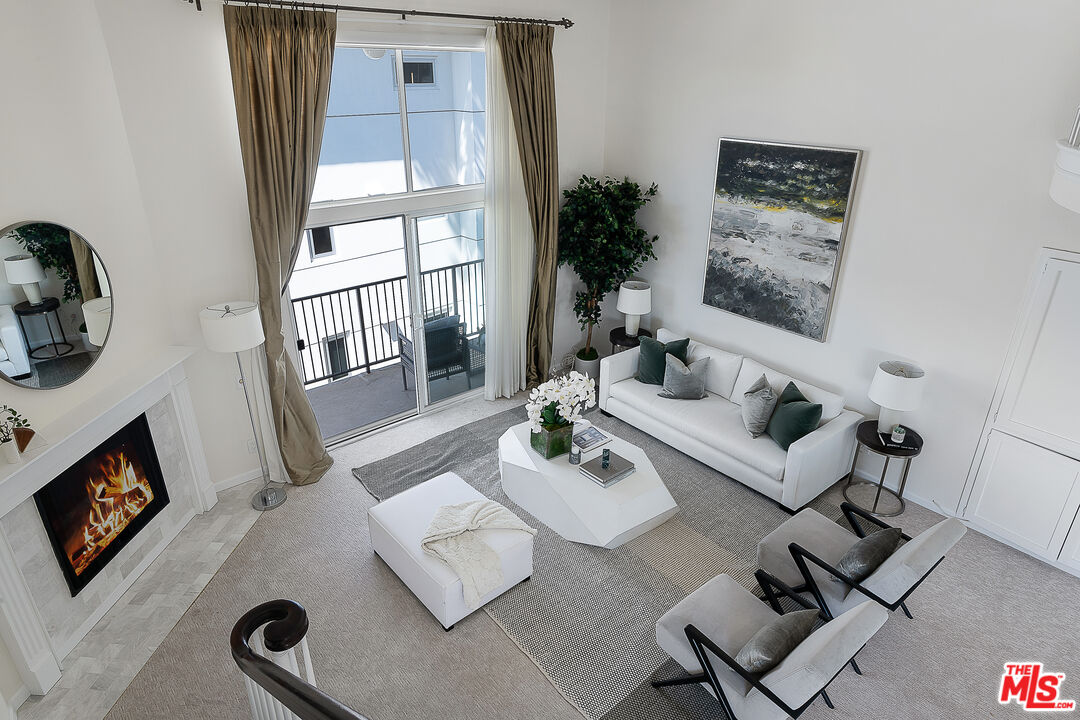 2385 Roscomare Road Los Angeles, CA 90077 - Photo 8 of 38 a living room with furniture rug and a flat screen tv