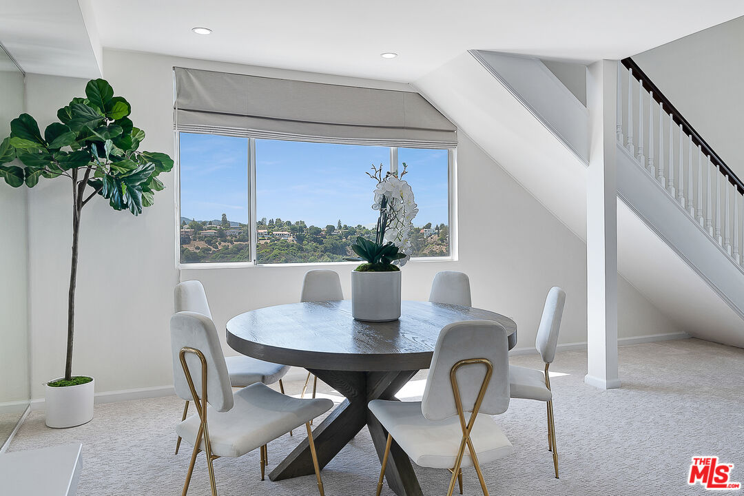 2385 Roscomare Road Los Angeles, CA 90077 - Photo 9 of 38 a view of a dining room with furniture window and wooden floor