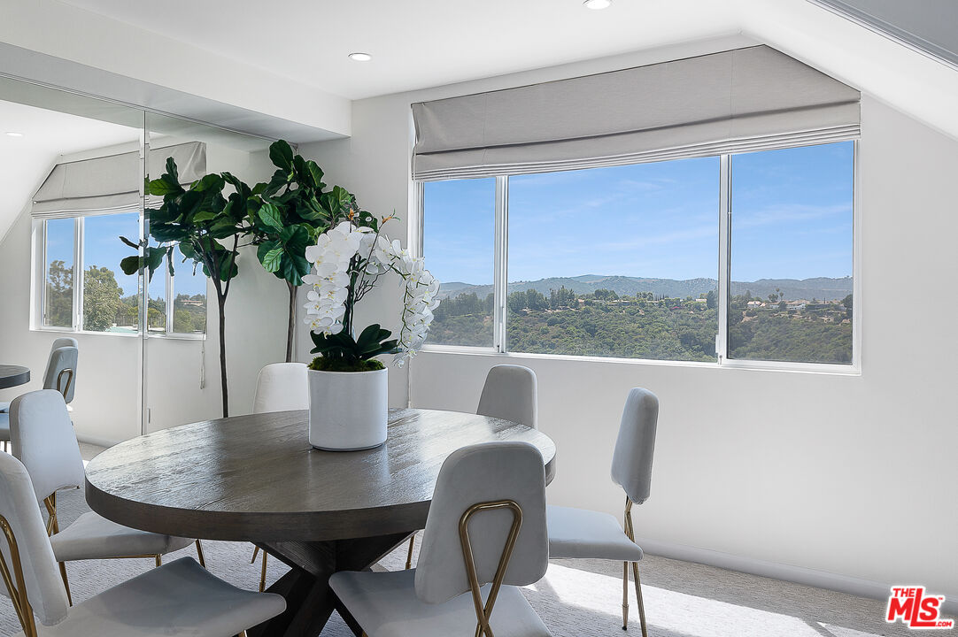 2385 Roscomare Road Los Angeles, CA 90077 - Photo 10 of 38 a dining room with furniture potted plants and wooden floor