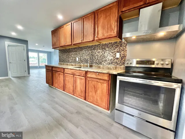 a stove top oven sitting inside of a kitchen