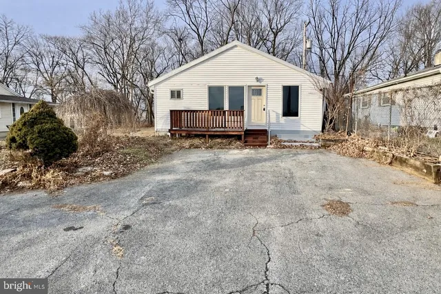a front view of a house with a yard covered in snow