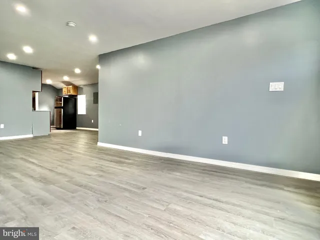 a view of a hall and an empty room