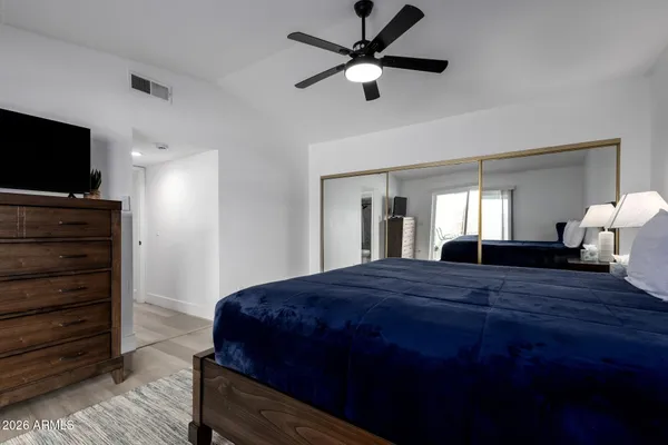 a bedroom with a bed and a flat screen tv