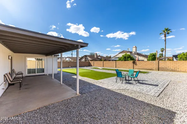 a view of a backyard with sitting area