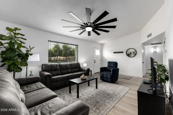 a living room with furniture a window and a chandelier