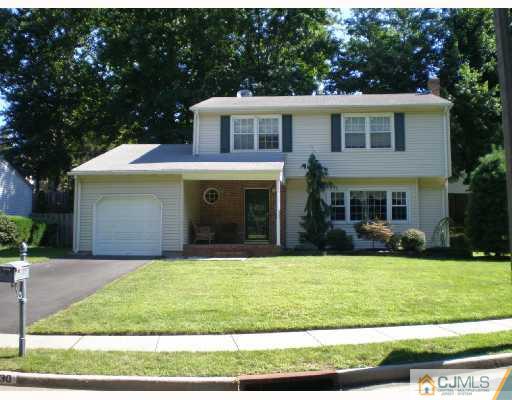 30 Brookside Road Edison, NJ 08817 - Photo 1 of 8 a front view of a house with a yard and garage