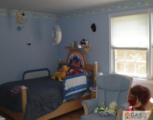 30 Brookside Road Edison, NJ 08817 - Photo 7 of 8 a bedroom with a bed and a window