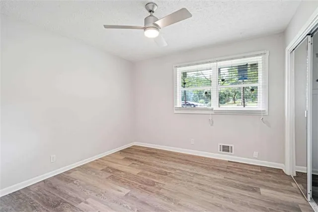 wooden floor in an empty room with a window