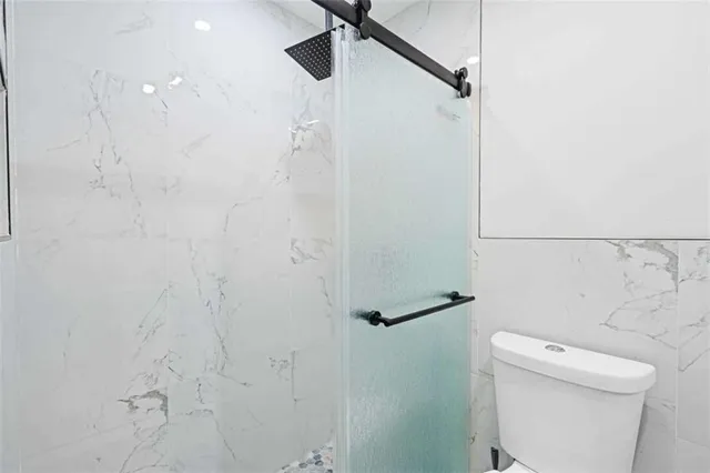 a bathroom with a shower and toilet
