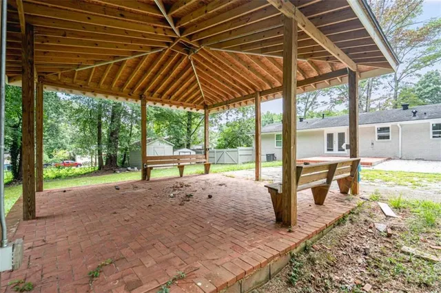 a view of a backyard with wooden floor and roof