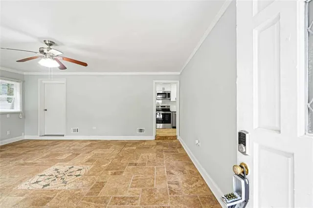 a view of an empty room with wooden floor