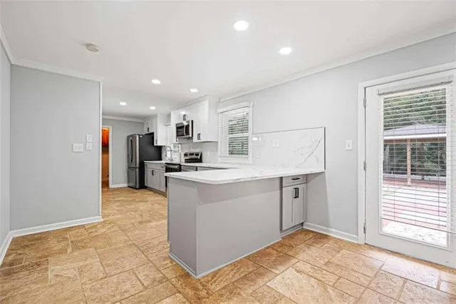 a kitchen with a refrigerator and a sink