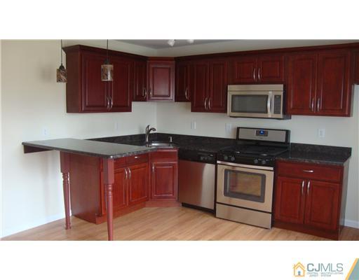 45 Princeton Road Old Bridge, NJ 08859 - Photo 2 of 10 a kitchen with stainless steel appliances granite countertop a stove microwave and sink