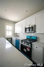 a kitchen with stainless steel appliances a stove a sink and a microwave