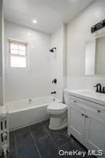 a bathroom with a sink toilet and bathtub