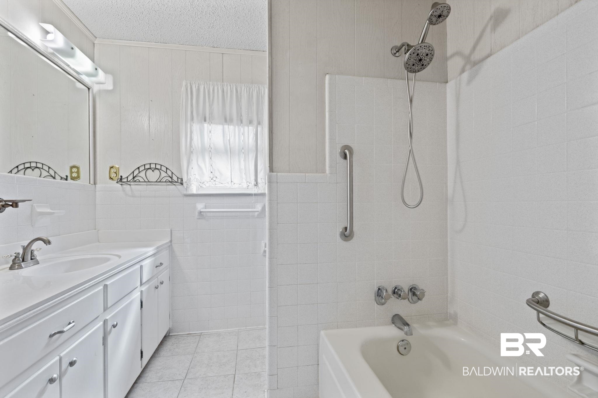 6261 Old Pascagoula Road Theodore, AL 36582 - Photo 21 of 29 Bathroom with tile walls, vanity, tiled shower / bath combo, and tile patterned floors