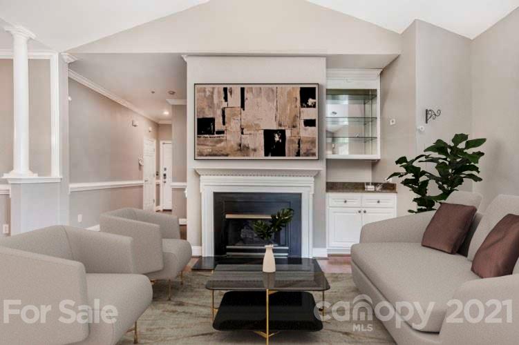 5730 Closeburn Road, Unit N Charlotte, NC 28210 - Photo 2 of 21 a living room with furniture a fireplace and a potted plant