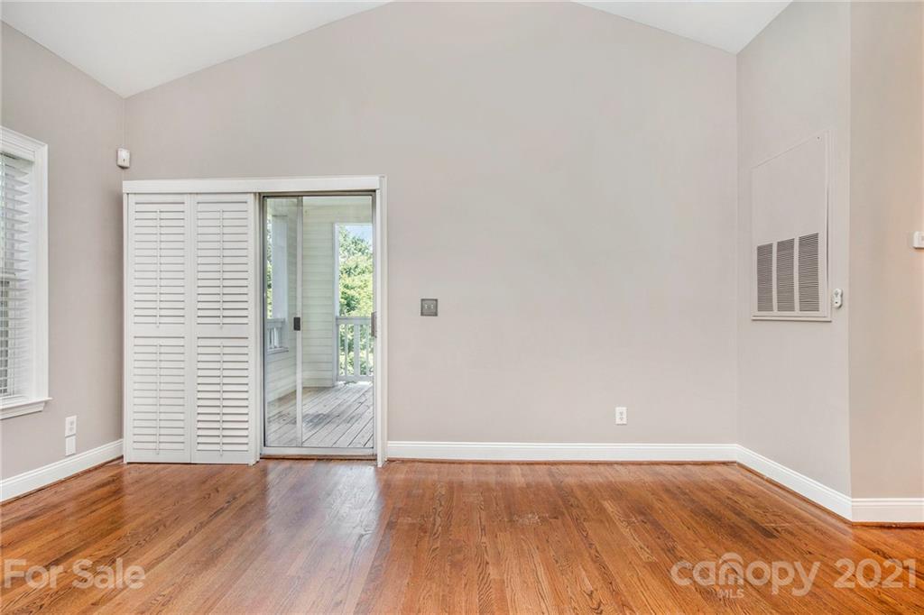 5730 Closeburn Road, Unit N Charlotte, NC 28210 - Photo 13 of 21 a view of an empty room with wooden floor and a window