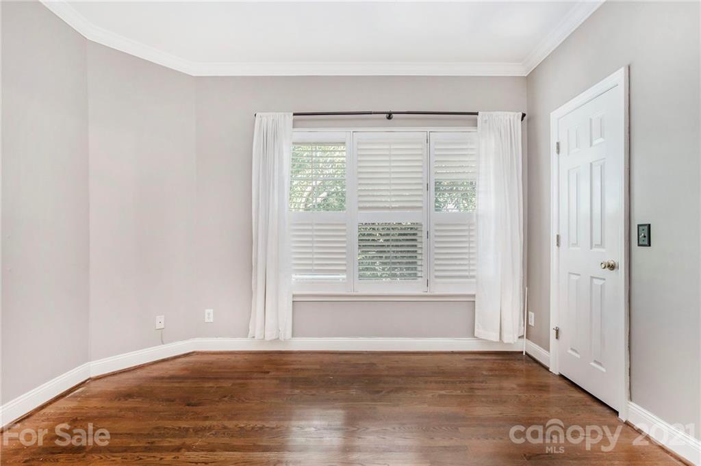 5730 Closeburn Road, Unit N Charlotte, NC 28210 - Photo 14 of 21 a view of an empty room with wooden floor and a window