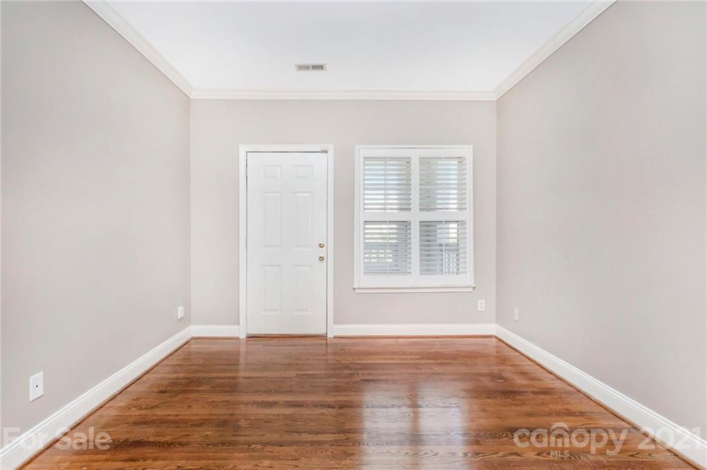 5730 Closeburn Road, Unit N Charlotte, NC 28210 - Photo 20 of 21 an empty room with wooden floor and windows