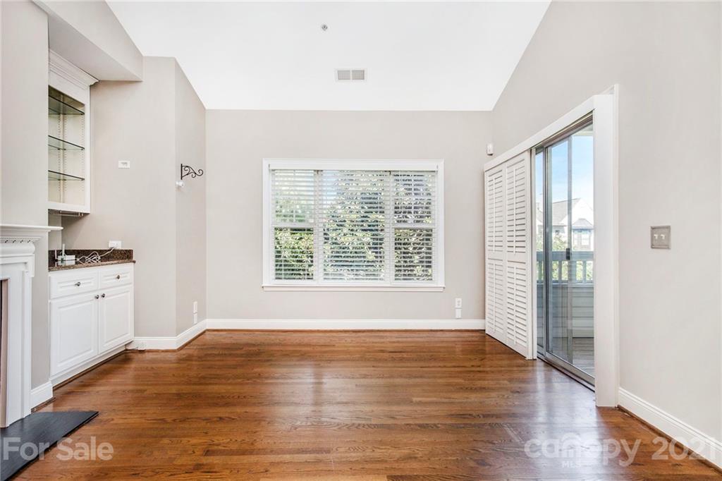 5730 Closeburn Road, Unit N Charlotte, NC 28210 - Photo 10 of 21 a view of empty room with wooden floor and fan