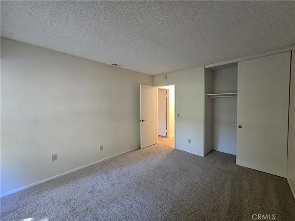 an empty room with closet area