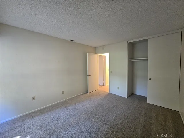 an empty room with closet area