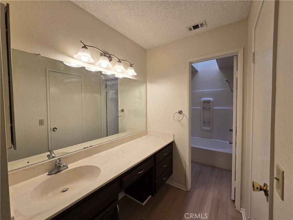 600 Central Avenue, Unit 386 Riverside, CA 92507 - Photo 15 of 21 a bathroom with a double vanity sink mirror and shower