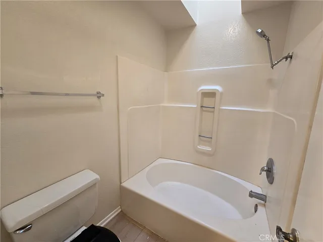 a bathroom with a tub and shower