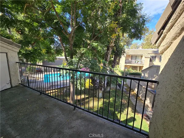 a view of a balcony with a pot