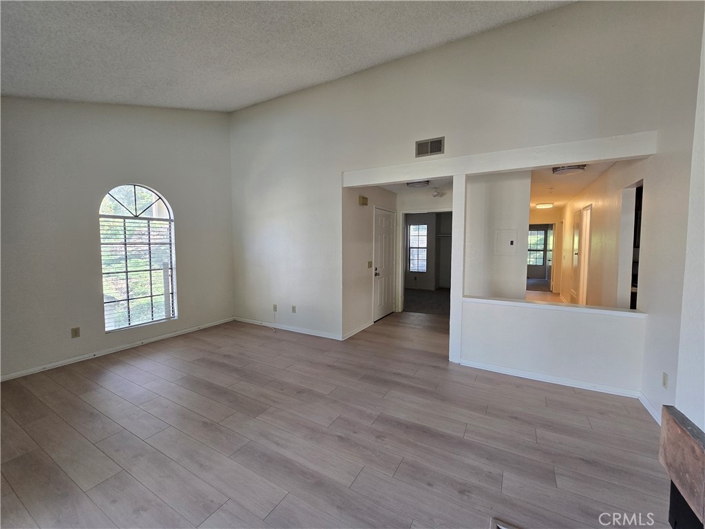 600 Central Avenue, Unit 386 Riverside, CA 92507 - Photo 2 of 21 wooden floor in an empty room with a window