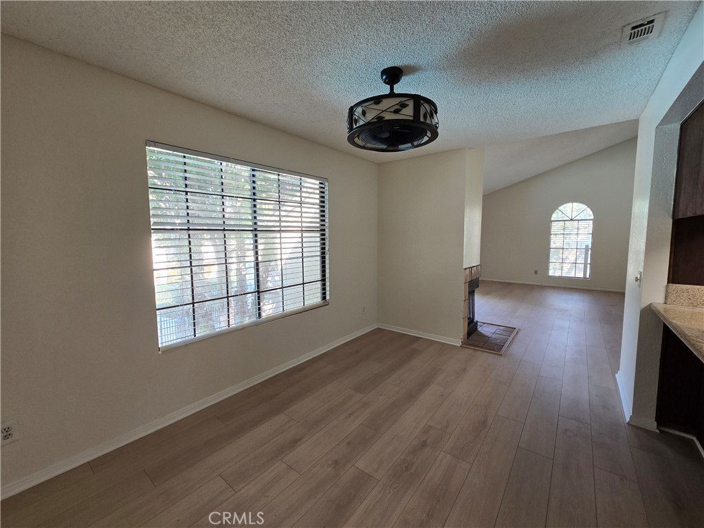 600 Central Avenue, Unit 386 Riverside, CA 92507 - Photo 5 of 21 a view of an empty room with a window and wooden floor