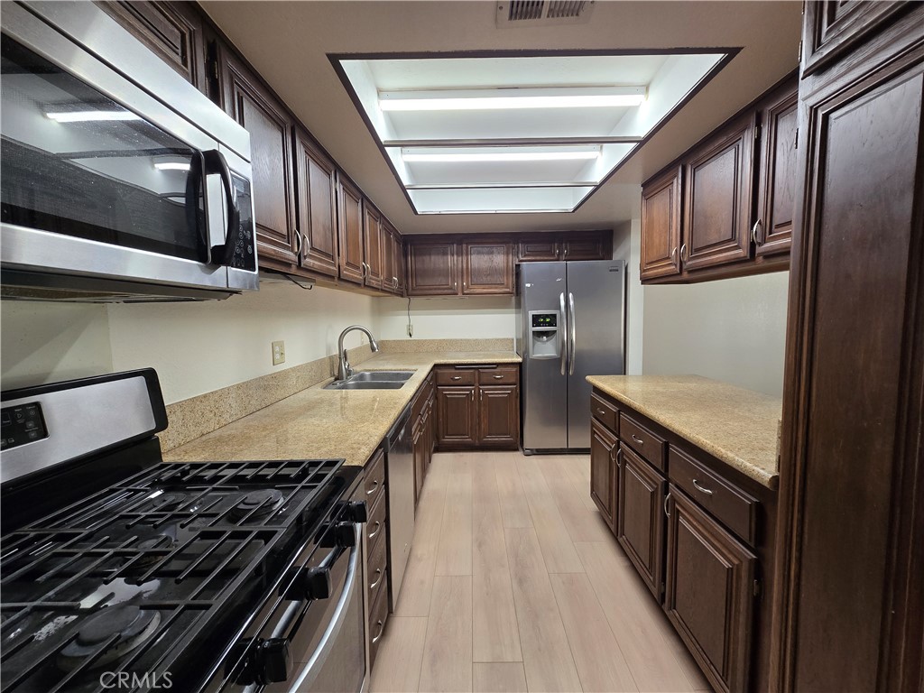 600 Central Avenue, Unit 386 Riverside, CA 92507 - Photo 6 of 21 a kitchen with stainless steel appliances granite countertop a stove and a sink