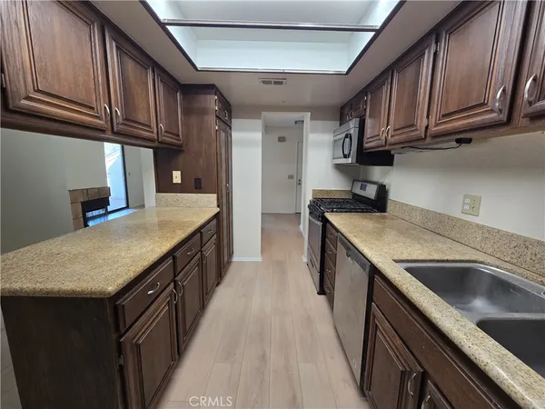 a kitchen with a sink stove and cabinets