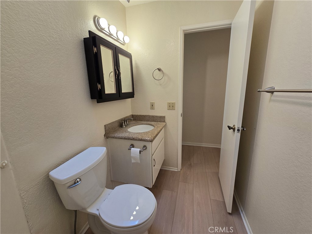 600 Central Avenue, Unit 386 Riverside, CA 92507 - Photo 10 of 21 a bathroom with a toilet a sink and mirror