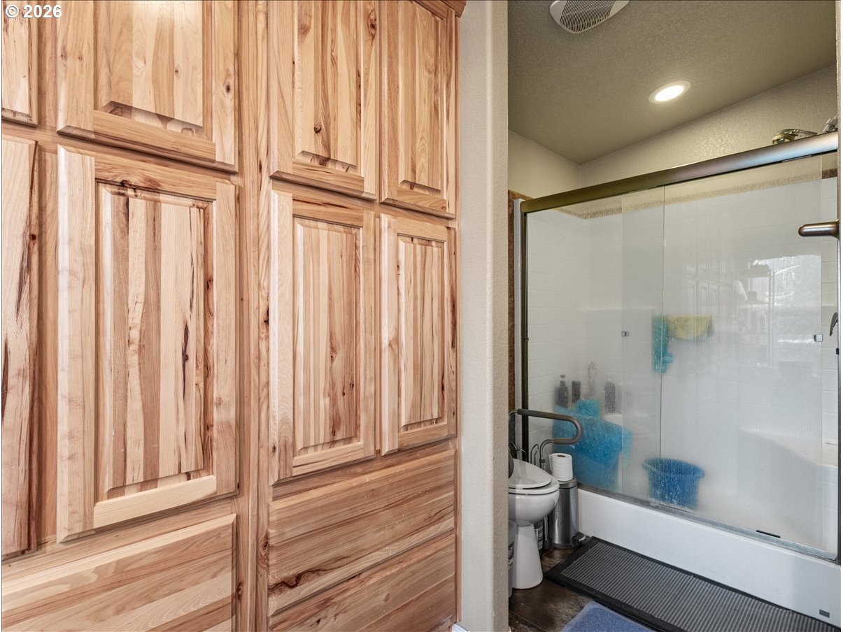 23728 Northeast Dole Valley Road Yacolt, WA 98675 - Photo 12 of 46 a bathroom with a granite countertop bathtub shower and toilet